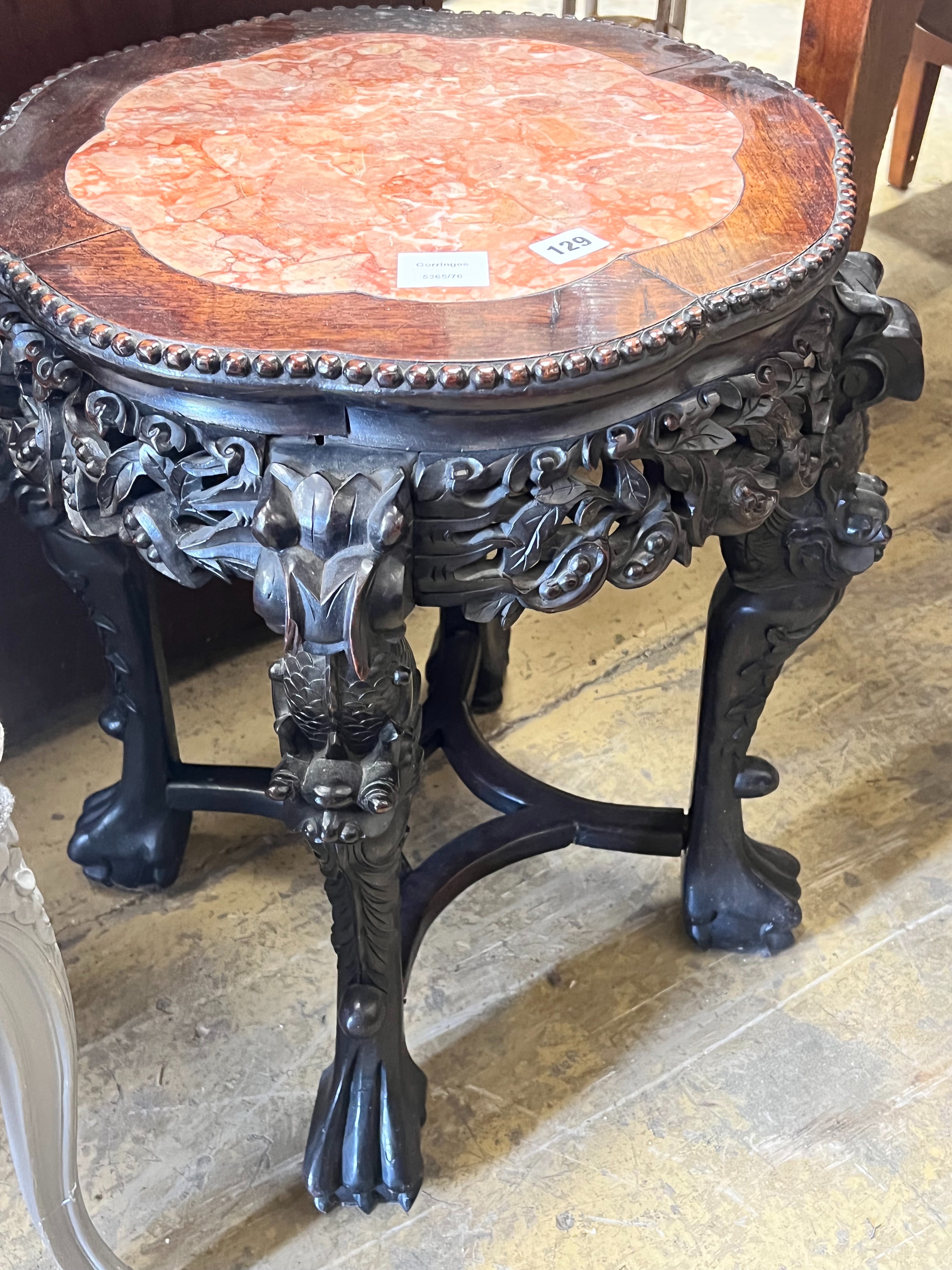 A Chinese carved hongmu circular marble topped jardiniere stand, diameter 46cm height 58cm